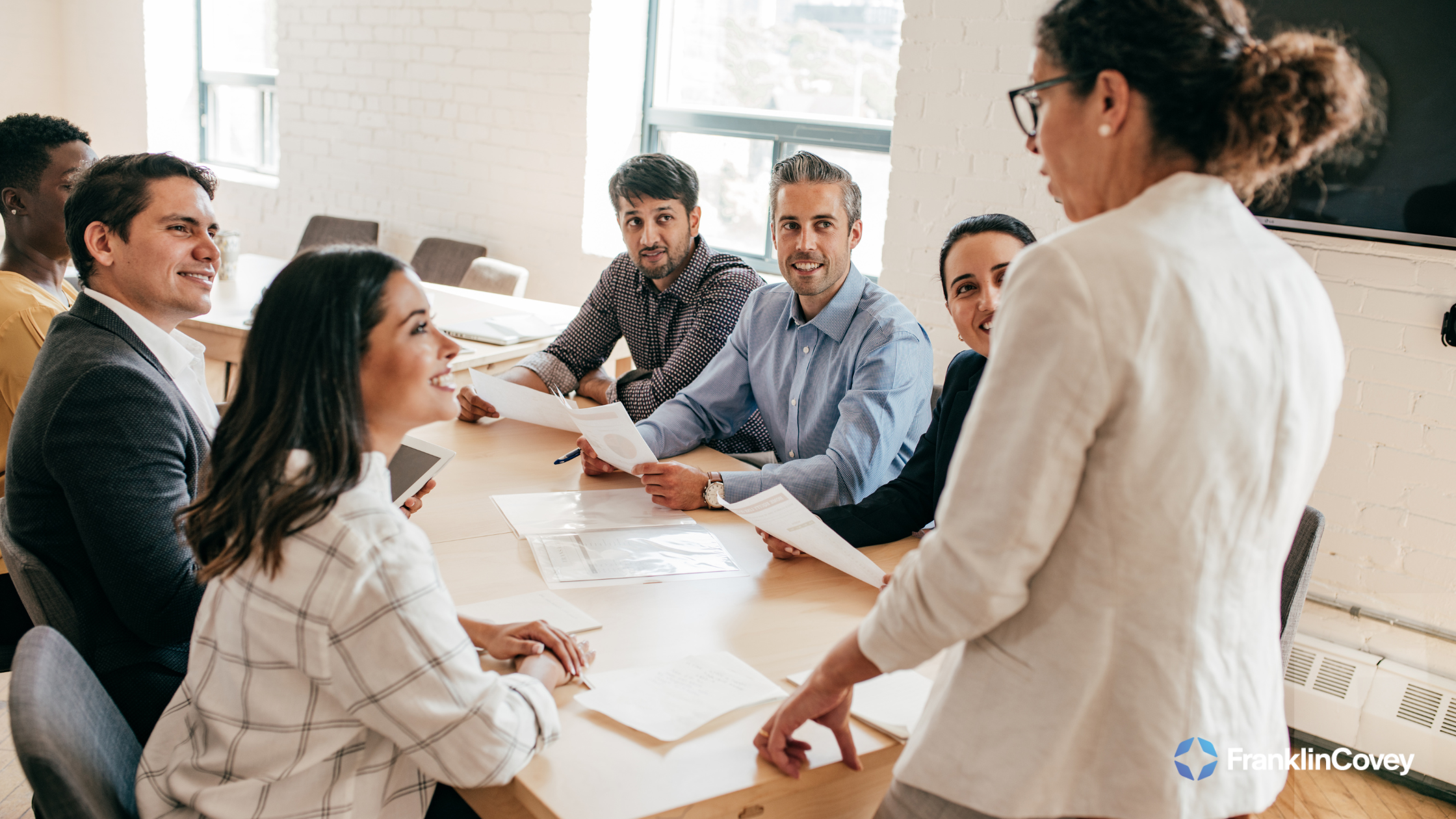 A business leader presenting strategies in a leadership training workshop.